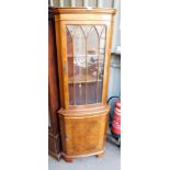 A yew wood corner cabinet.