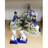 A group of Staffordshire style figures, to include two cats on blue cushions, two figures on horseba