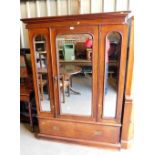 A Victorian mahogany double wardrobe, with central mirrored door and two small panelled mirrored doo