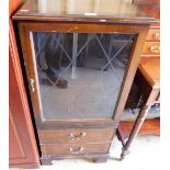 A mahogany finish glazed cabinet with two drawers.