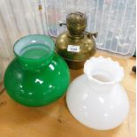 A brass oil lamp reservoir and two glass shades.