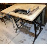 A Singer sewing machine table, with pine top and Singer sewing machine section with cast iron ends m