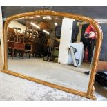 A gilt framed overmantel mirror, the central top design with flowers and leaves, and beaded detailin