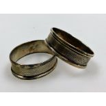 Two George V oval silver napkin rings, each with engine turned decoration and vacant shield, Birming