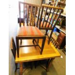 An oak square extending dining table and four mahogany chairs.