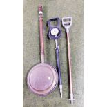 A copper warming pan and two shooting sticks.