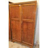 An oak double wardrobe, with reeded top opening to reveal glazed top section above selection of draw