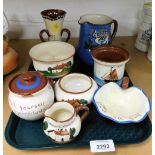 A small group of Torquay ware, to include miniature milk jugs, ashtrays, vases, etc. (1 shelf)