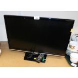 A Samsung flat screen 21" television with remote control.