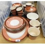 A part dinner service with brown outer border on a pink ground, with meat plates, side plates, cups