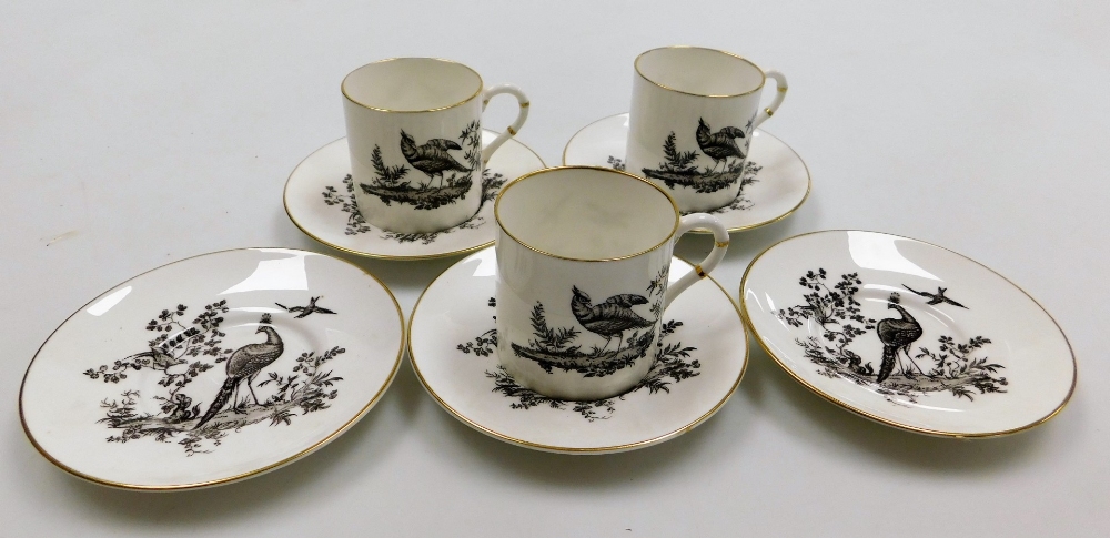 Three Royal Worcester coffee cans and five saucers, each decorated with a blackbird, with black stam