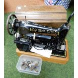 A cased Singer sewing machine in wooden case.