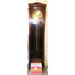 A 1930s oak cased longcase clock, with brass clock face, with floral banded arched top and mirrored