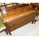 An oak low chest, with mounted cornice back above two drawers with drop handles on reeded supports.