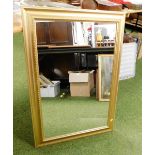 A modern rectangular gilt framed wall mirror.