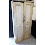 A painted pine storage cabinet, with two plank doors. (AF)