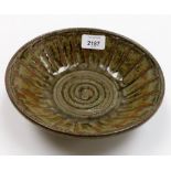 A Ray Gardiner studio pottery stoneware bowl, in a green and red mottled glaze, with trident impress