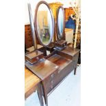An Edwardian mahogany dressing table, with oval triple mirror plate, and two single drawers above tw