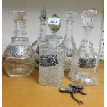 Five cut and pressed glass decanters, each with silver plated decanter label.