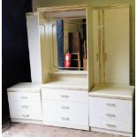 A bedroom suite, in a mottled marble effect finish in the Art Deco style, comprising wardrobe dressi