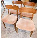 A set of four retro dining chairs, each with curved back on pink upholstered seats. The upholstery