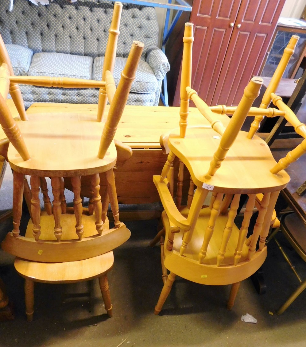 A pine drop leaf kitchen table and four chairs.