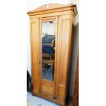A yew wood single wardrobe, with shaped cornice above rectangular glazed door with two side panels o