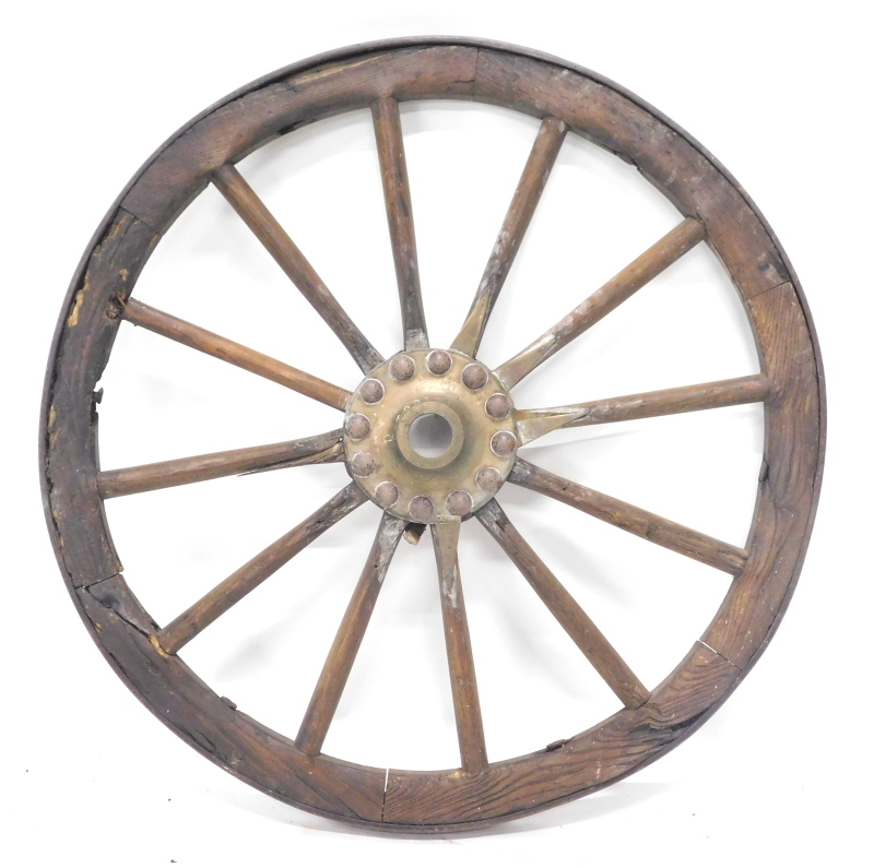 A late 19th/ early 20thC elm and iron cartwheel, with central boss indistinctly signed, stamped