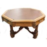 A Victorian carved oak library table in the manner of Pugin, the octagonal top with a brown