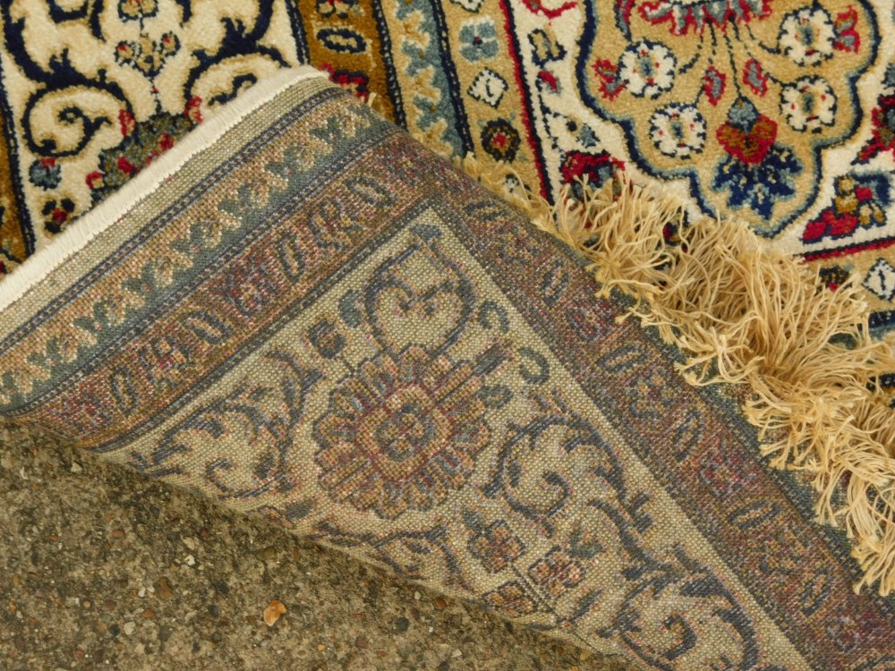 A machine woven mercerised cotton rug, in the Persian style, decorated with flowers, within - Image 3 of 3