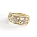 A 9ct gold dress ring, with rectangular panel set with three flowers and six leaf design, each set