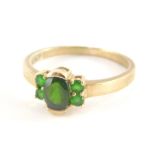 A 9ct gold dress ring, with central oval cut peridot, flanked by four peridots, each in claw