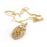 A 9ct gold pendant and chain, the floral pendant set with citrine, 3cm high, on a fine link chain,