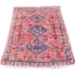 A Persian rug, with a central pole medallion, on a red ground with one wide and one narrow border,