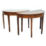 A pair of George III mahogany and satinwood crossbanded demi lune tables, each inlaid with fans,