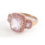 A 9ct rose gold dress ring, set with pink and purple topaz stones, with rectangular central purple