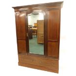 An Edwardian mahogany and inlaid wardrobe, the central mirror door, above two drawers, 206cm high,