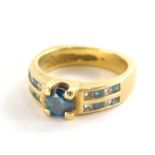 An 18ct gold diamond dress ring, the central blue diamond in four claw setting, approx 0.77cts, with