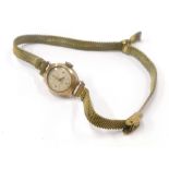 A ladies Audax 9ct gold watch head, with gilt metal strap.