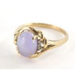 A 9ct gold dress ring, with central pale purple cabachon cut amethyst, and cz set shoulders and