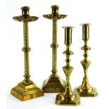 A pair of 19thC brass candlesticks, with a flare shaped drip tray, twisted stems, on square pedestal