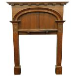 An early 20thC oak Arts and Crafts style fire surround, with moulded bow shaped mantle, a slatted