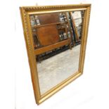 A late 19th/ early 20th gilt gesso wall mirror, 113cm x 92cm.