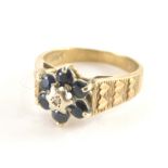 A 9ct gold cluster ring, with six sapphires and central illusions set tiny diamond and three layered