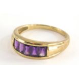 A 9ct gold half hoop dress ring, with five rectangular cut amethysts, in a tension setting on yellow