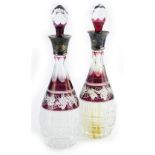 A pair of 19th/early 20thC Bohemian glass decanters, each with a silver collar, the body decorated