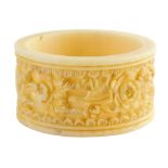 A late 19th/early 20thC Chinese Canton ivory napkin ring, carved with flowers, with blackened
