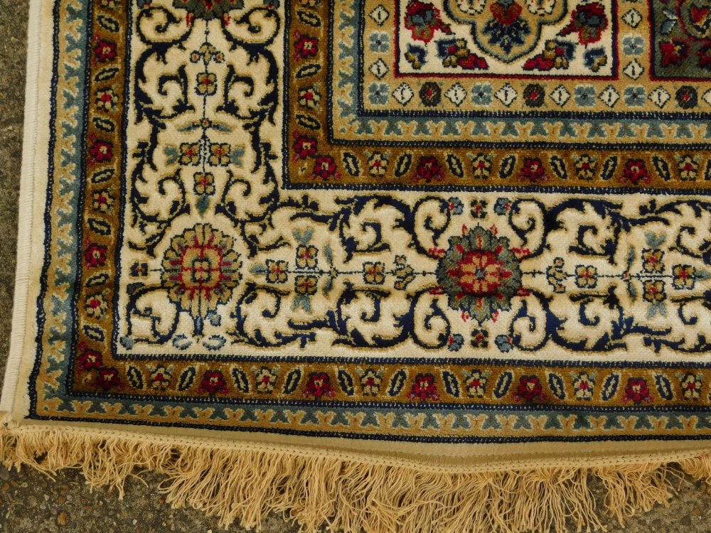 A machine woven mercerised cotton rug, in the Persian style, decorated with flowers, within - Image 2 of 3