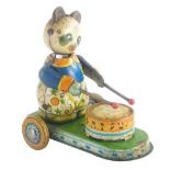 A mid 20thC tin plate wind up model toy of a panda playing a drum, 12cm high, 13cm wide.