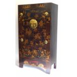 An oriental lacquered cupboard, decorated overall in raised gilt with warriors on horseback, and